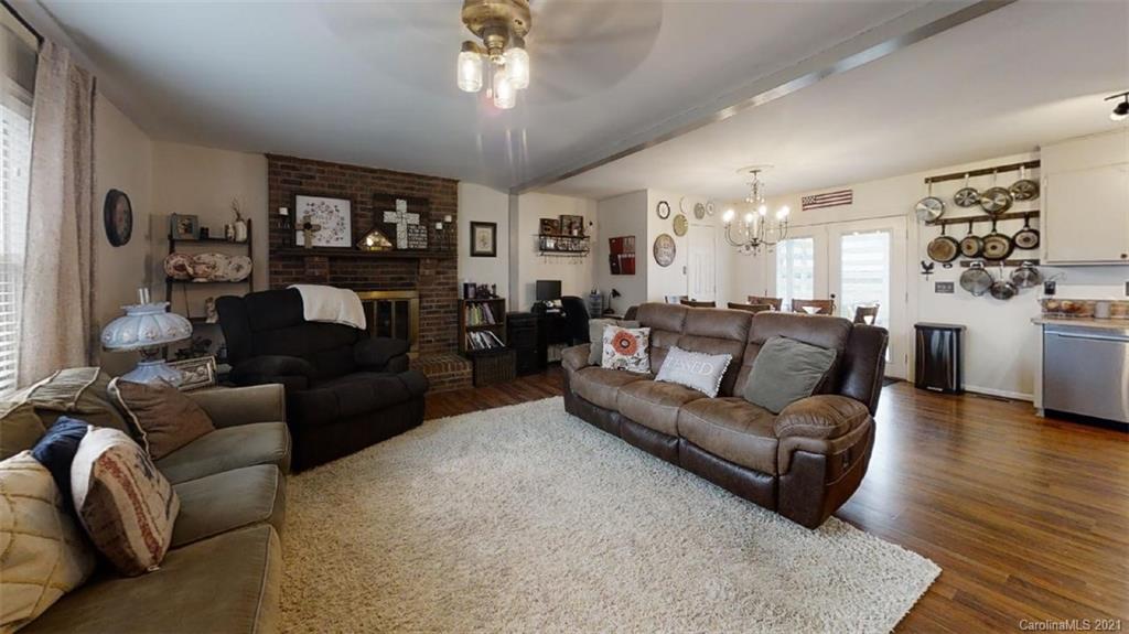 228 Huffstetler Lake Road Dallas, NC 28034 - Photo 8 of 27 a living room with furniture and a wooden floor