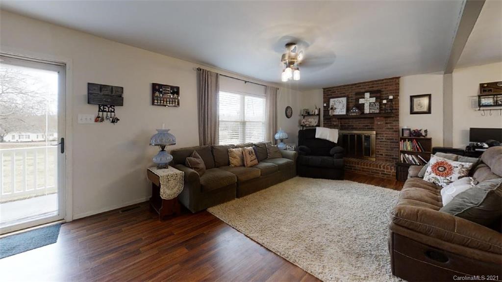 228 Huffstetler Lake Road Dallas, NC 28034 - Photo 10 of 27 a living room with furniture and wooden floor