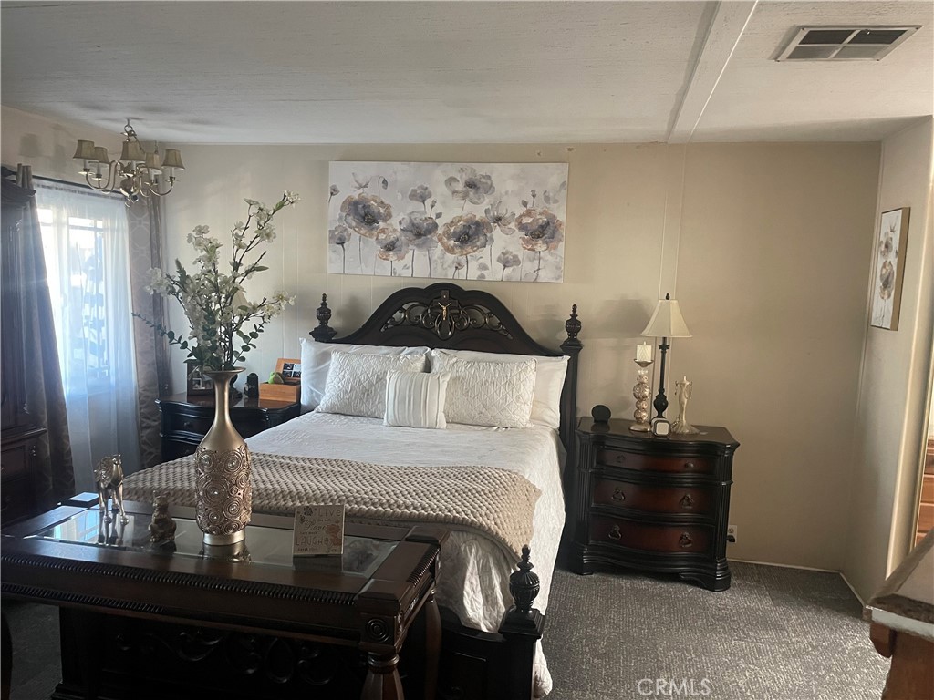 300 North Rampart Street, Unit 157 Orange, CA 92868 - Photo 11 of 14 a bedroom with a bed and dresser