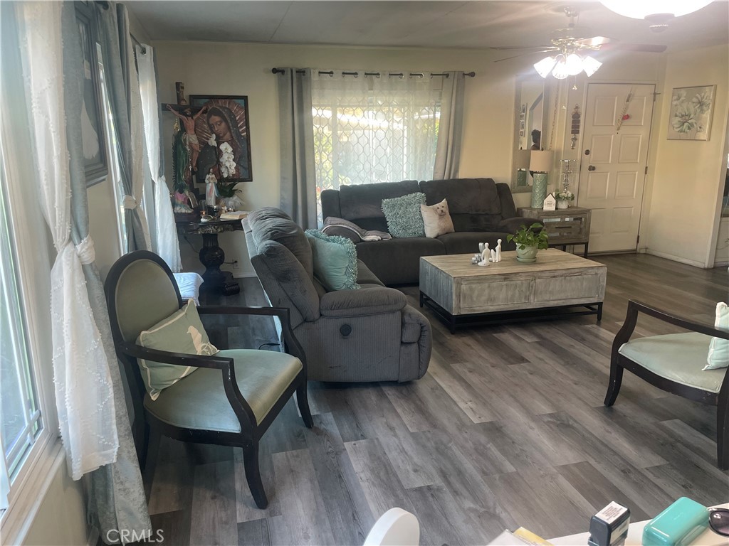 300 North Rampart Street, Unit 157 Orange, CA 92868 - Photo 13 of 14 a living room with furniture and a wooden floor