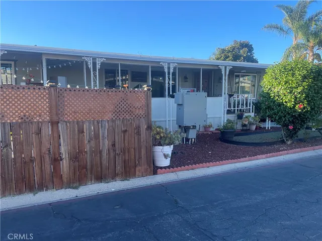 a front view of a house with a garden and plants