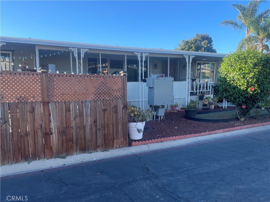 300 North Rampart Street, Unit 157 Orange, CA 92868 - Photo 4 of 14 a front view of a house with a garden and plants