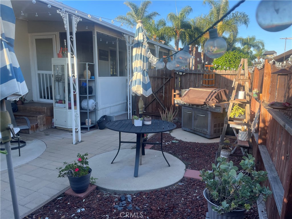 300 North Rampart Street, Unit 157 Orange, CA 92868 - Photo 6 of 14 a view of a patio with table and chairs potted plants