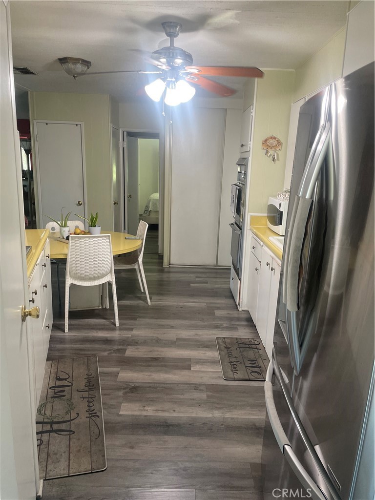 300 North Rampart Street, Unit 157 Orange, CA 92868 - Photo 8 of 14 a dining room with furniture a chandelier and wooden floor