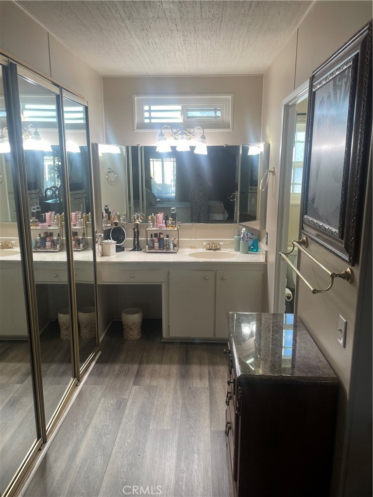 300 North Rampart Street, Unit 157 Orange, CA 92868 - Photo 9 of 14 a room with a refrigerator a sink a mirror and a glass door shower