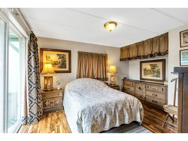 a bedroom with a bed and a large window