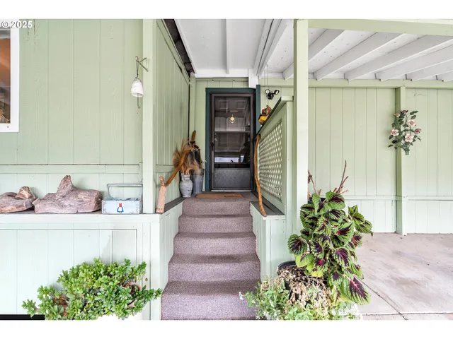 a living room with furniture a flat screen tv and a large window