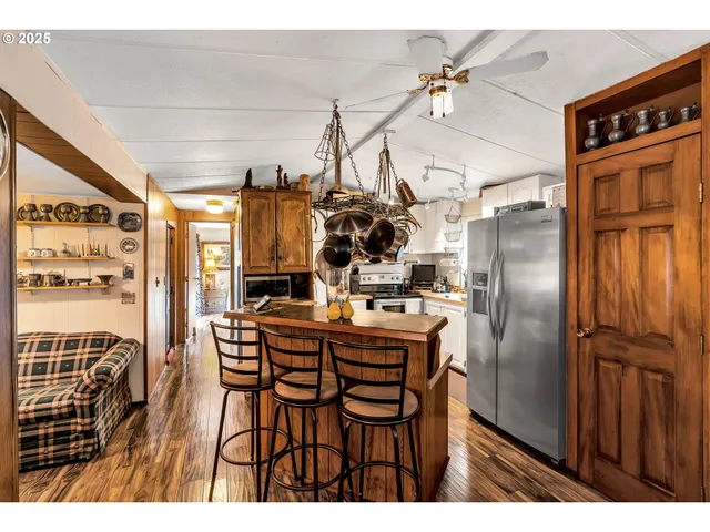 a kitchen with stainless steel appliances granite countertop a stove and a microwave