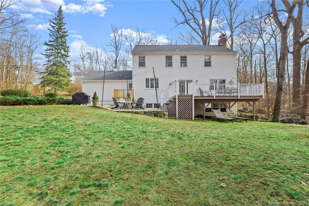 183 Frogtown Road New Canaan, CT 06840 - Photo 2 of 37 a view of a house with a big yard and large trees