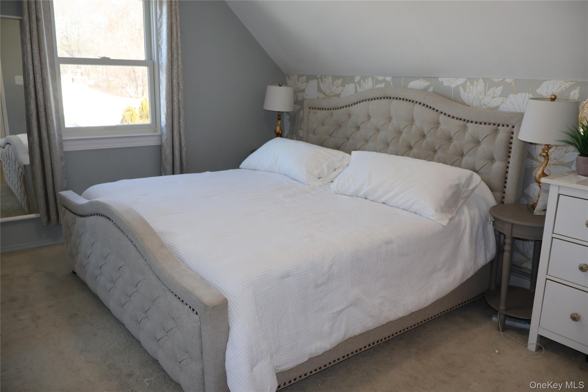 117 North Coleman Road Centereach, NY 11720 - Photo 12 of 29 a large bed sitting in a bedroom next to a window