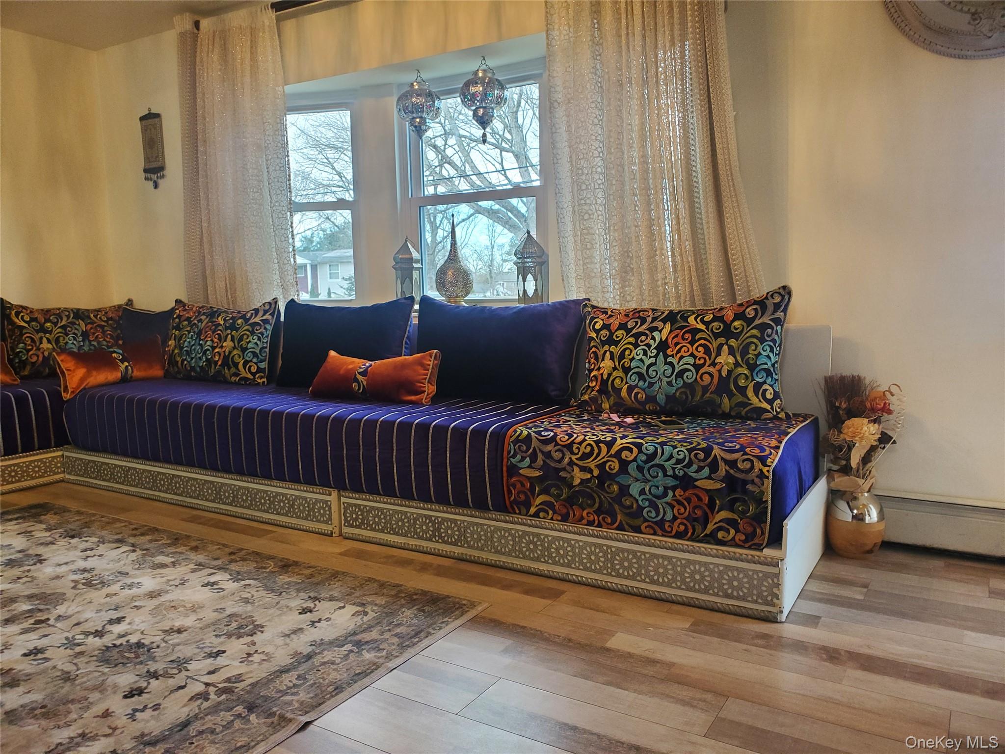 117 North Coleman Road Centereach, NY 11720 - Photo 12 of 26 Living area with wood finished floors and baseboard heating