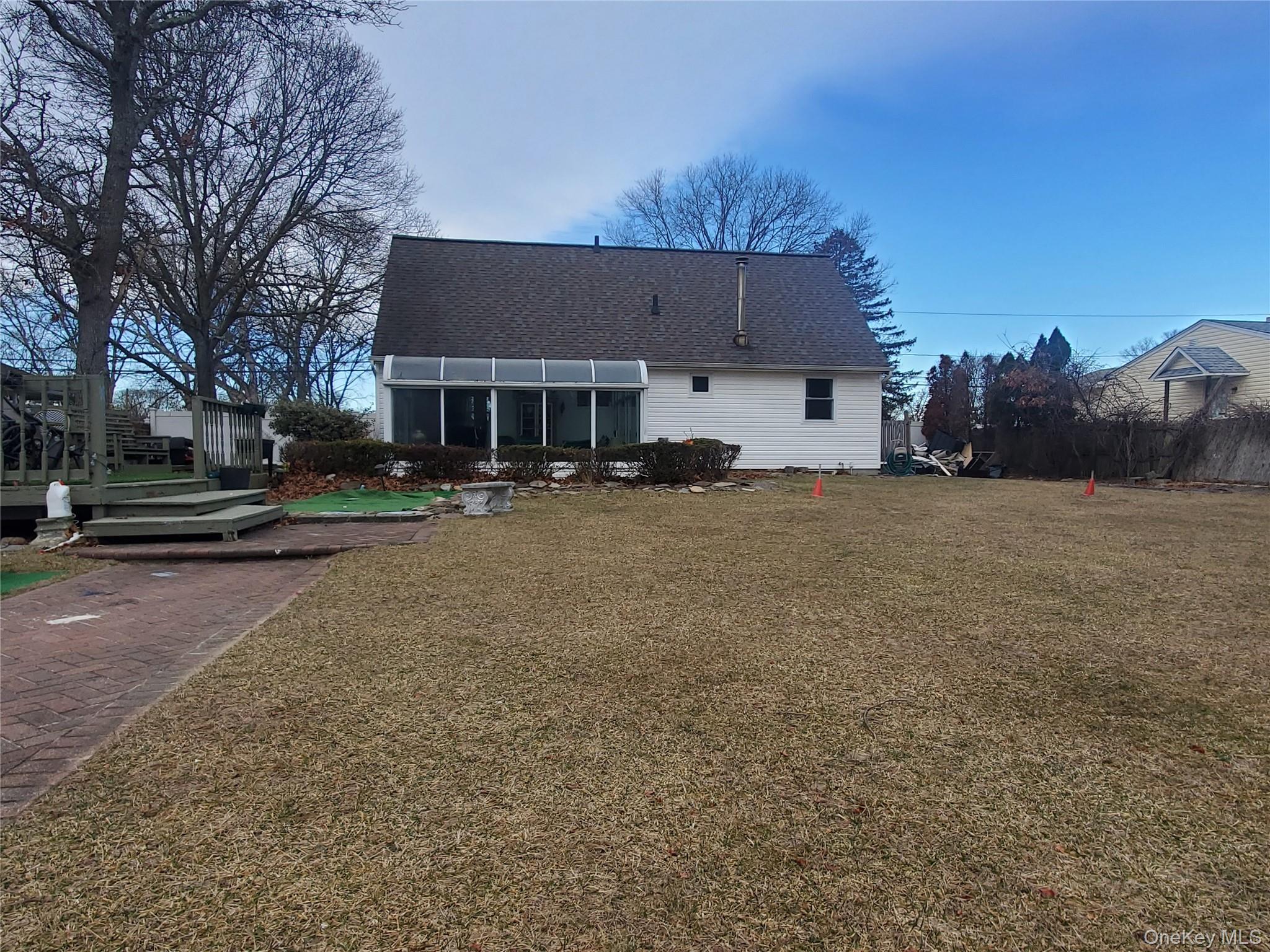 117 North Coleman Road Centereach, NY 11720 - Photo 19 of 26 Rear view of property featuring a sunroom