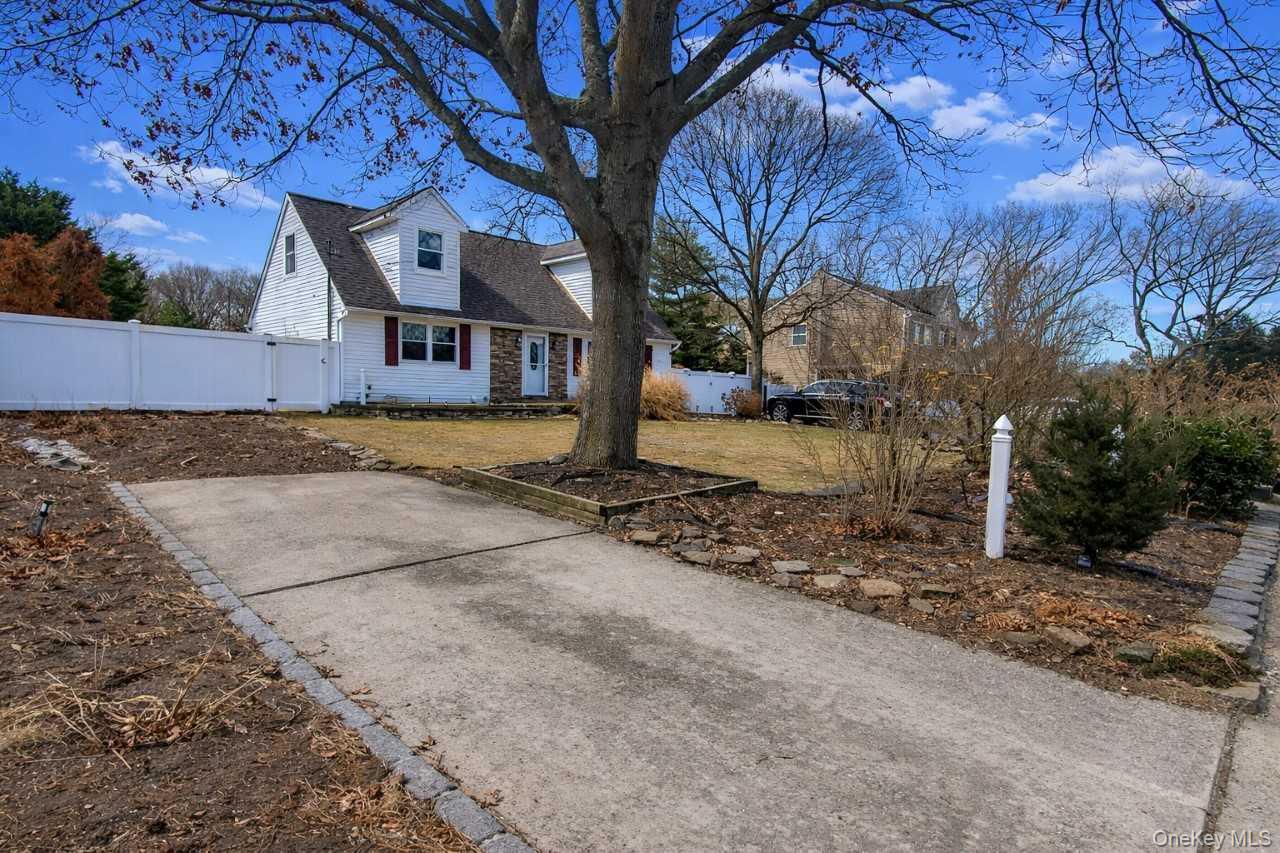 117 North Coleman Road Centereach, NY 11720 - Photo 21 of 29 a view of a house with a yard covered with snow in the background