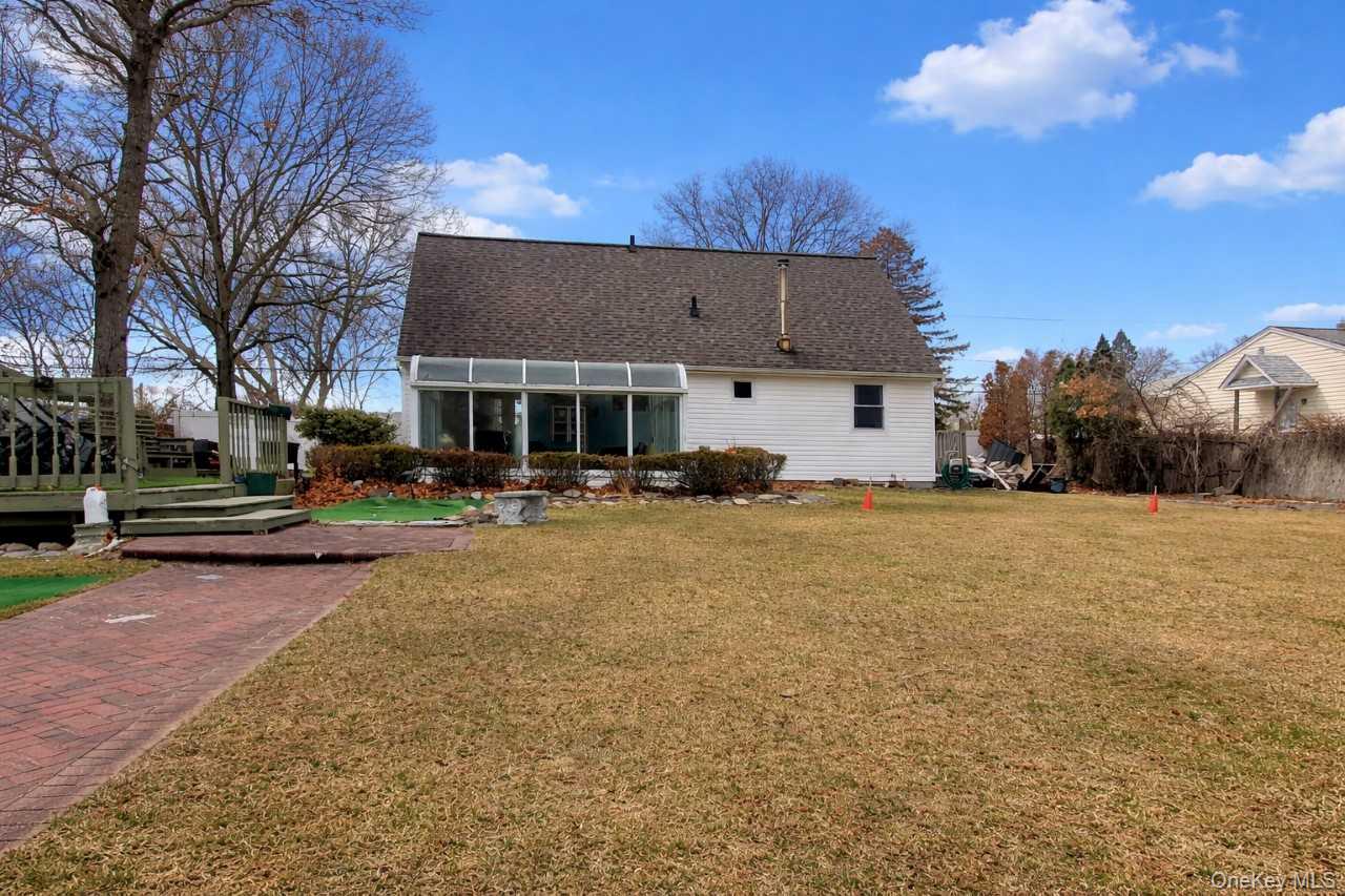117 North Coleman Road Centereach, NY 11720 - Photo 27 of 29 a front view of residential houses with yard and trees