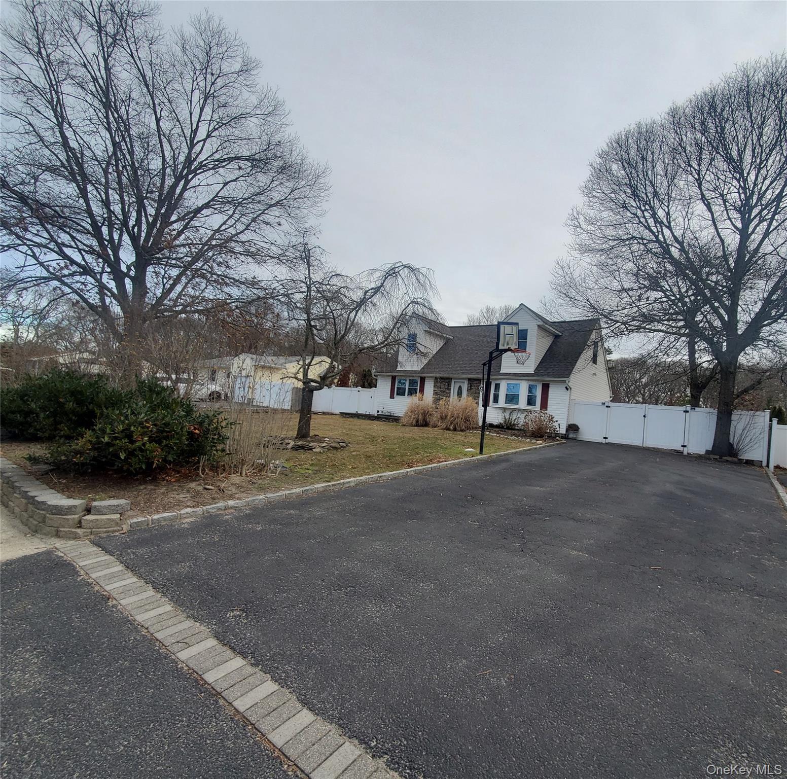 117 North Coleman Road Centereach, NY 11720 - Photo 3 of 26 View of asphalt street featuring a gate and curbs