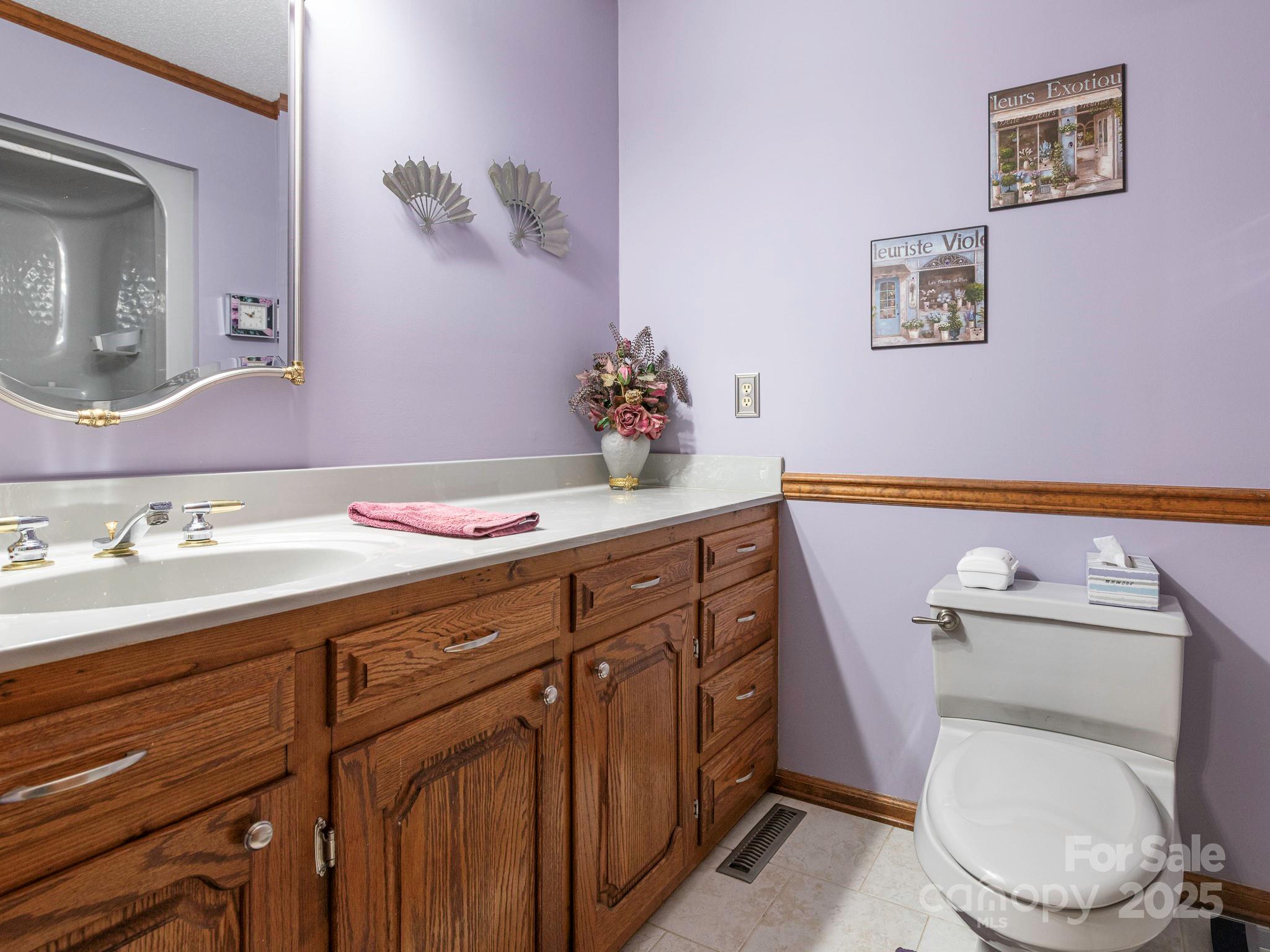 1800 Lake Lynn Road Concord, NC 28025 - Photo 11 of 45 a bathroom with a toilet a sink and mirror