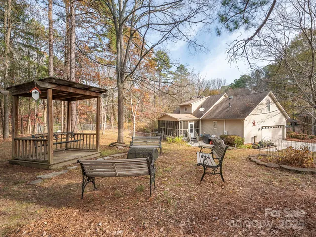 a view of a house with a yard and sitting area