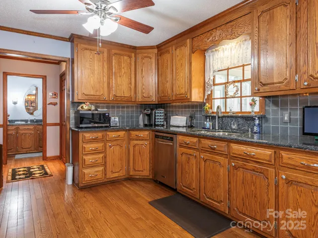 a kitchen with stainless steel appliances sink cabinets and window