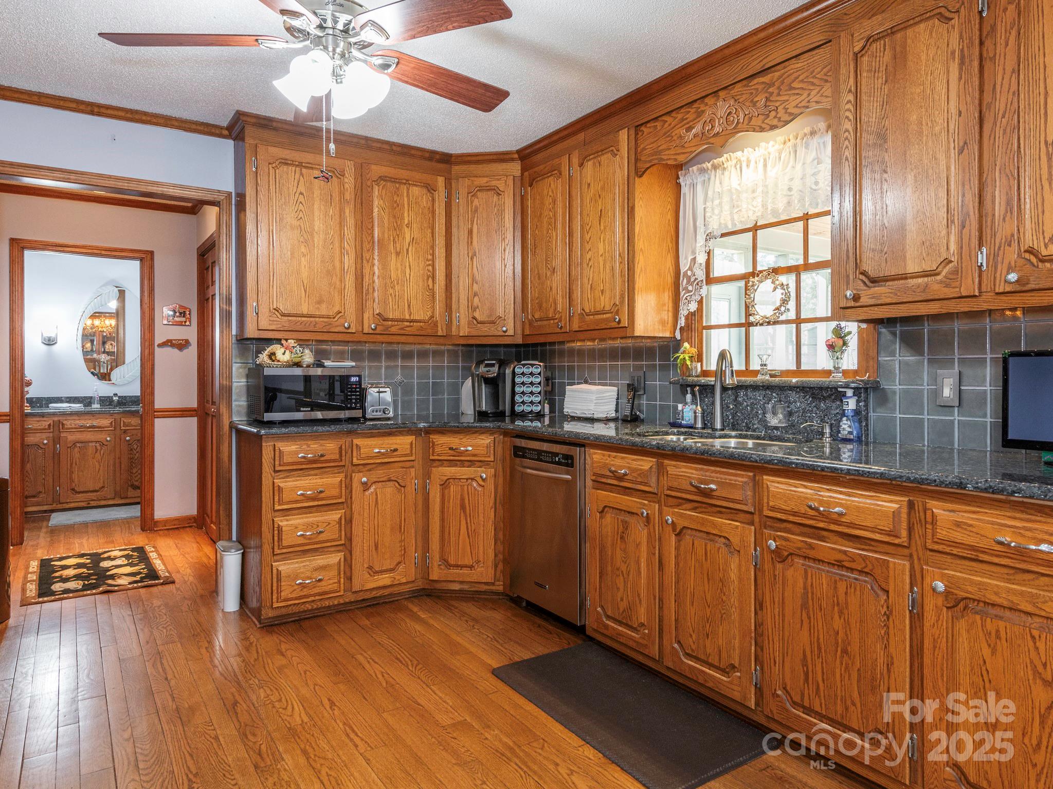 1800 Lake Lynn Road Concord, NC 28025 - Photo 23 of 45 a kitchen with stainless steel appliances sink cabinets and window