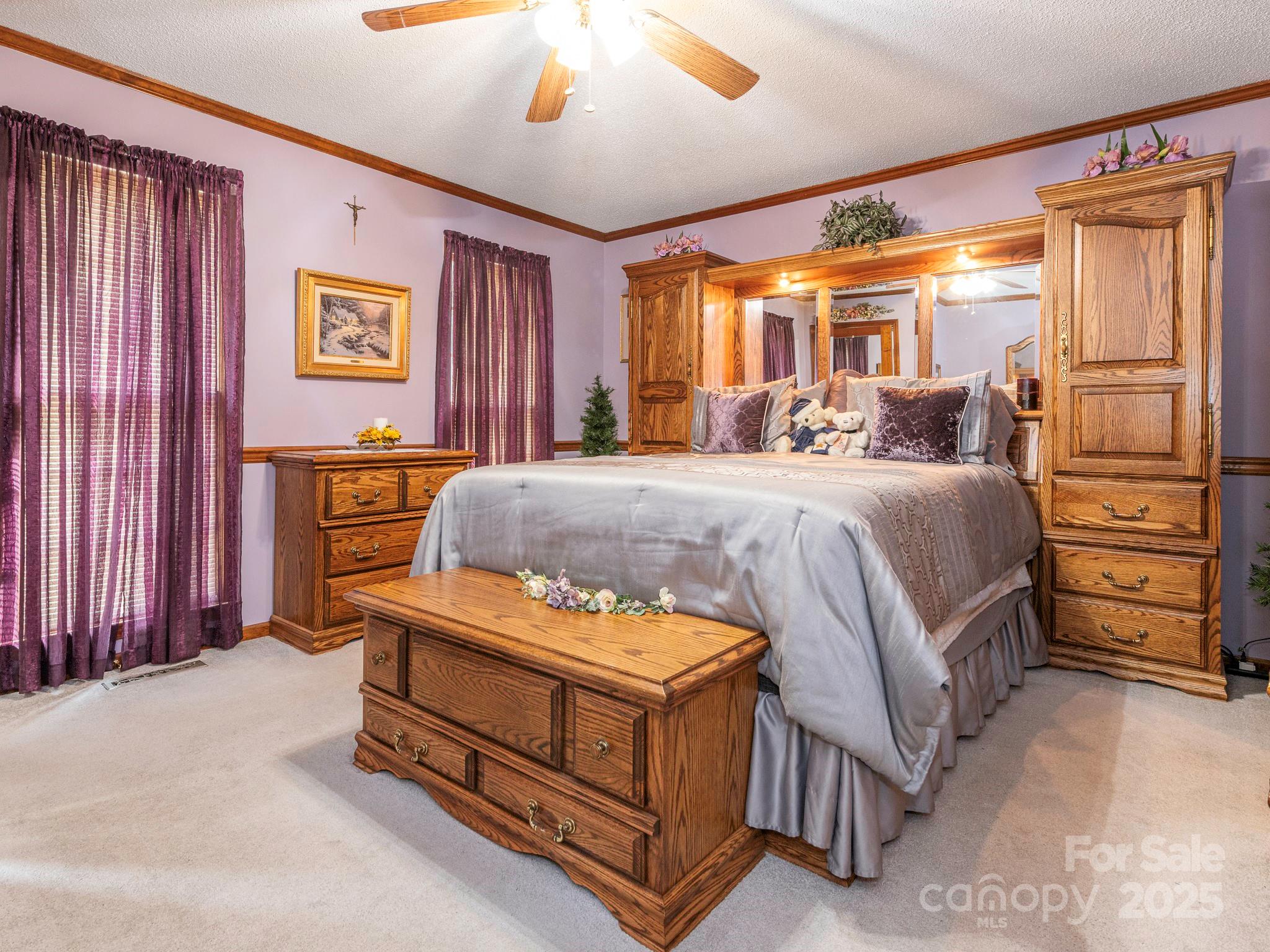 1800 Lake Lynn Road Concord, NC 28025 - Photo 28 of 45 a bedroom with a bed next to a window and a chandelier