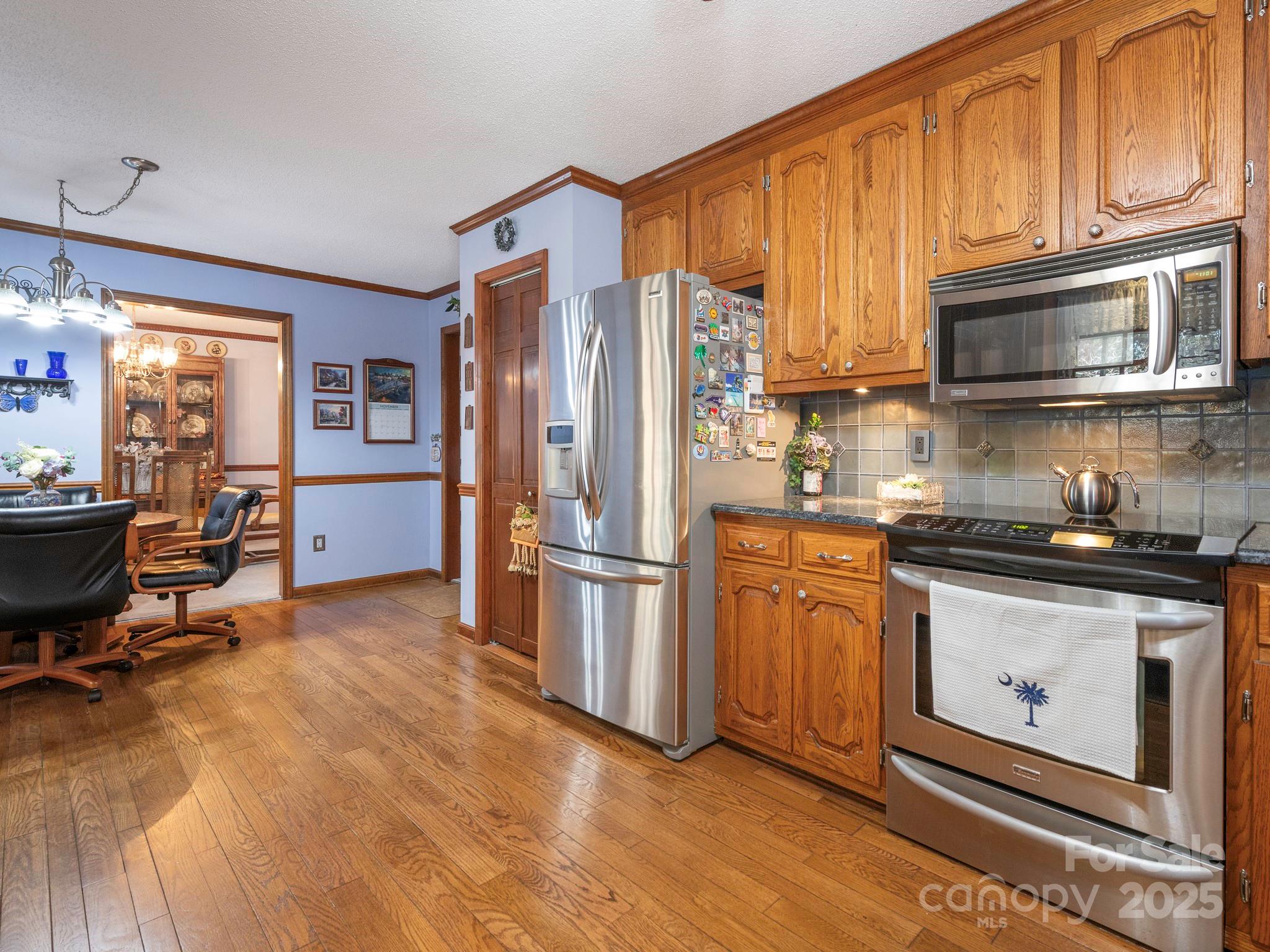 1800 Lake Lynn Road Concord, NC 28025 - Photo 37 of 45 a kitchen with stainless steel appliances granite countertop a refrigerator stove top oven a sink and dishwasher