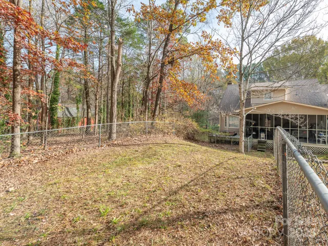 a view of a field with trees in the background