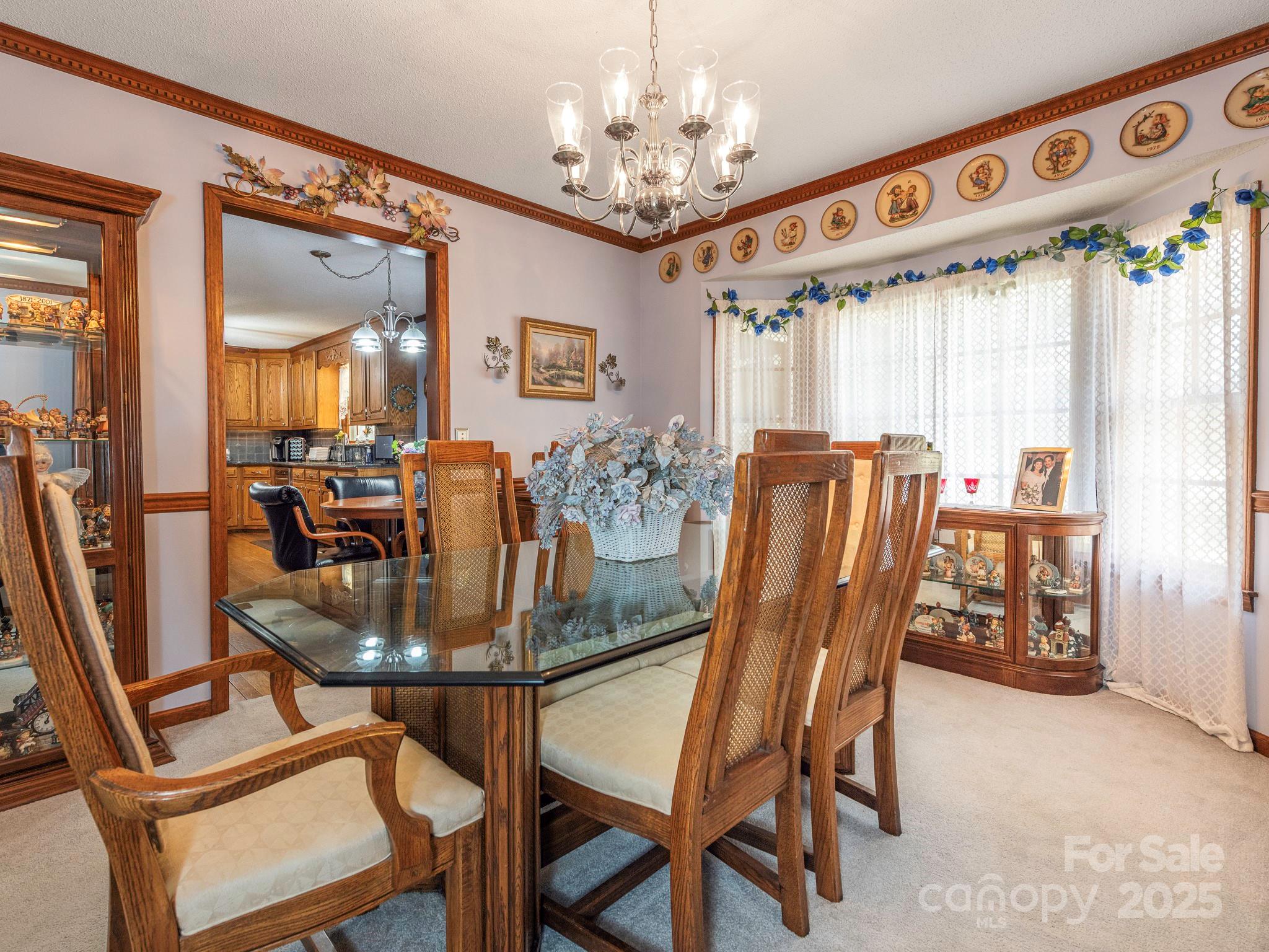 1800 Lake Lynn Road Concord, NC 28025 - Photo 8 of 45 a dining room with furniture a chandelier and window