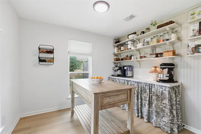 a kitchen with stainless steel appliances granite countertop a refrigerator a stove and a wooden floor