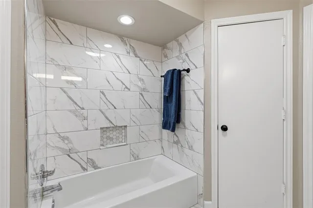 a bathroom with a granite countertop sink a toilet and a large mirror