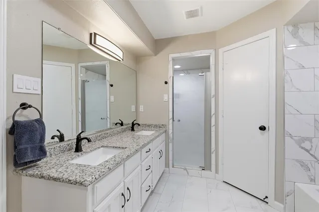 a bathroom with a tub sink and mirror