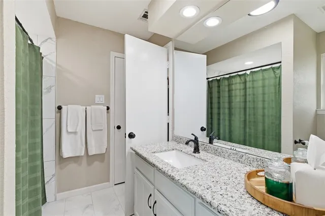 a living room with furniture and a book shelf