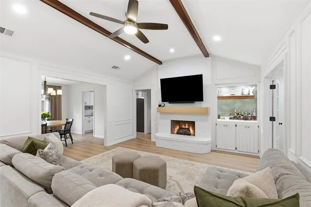 a living room with furniture and a ceiling fan