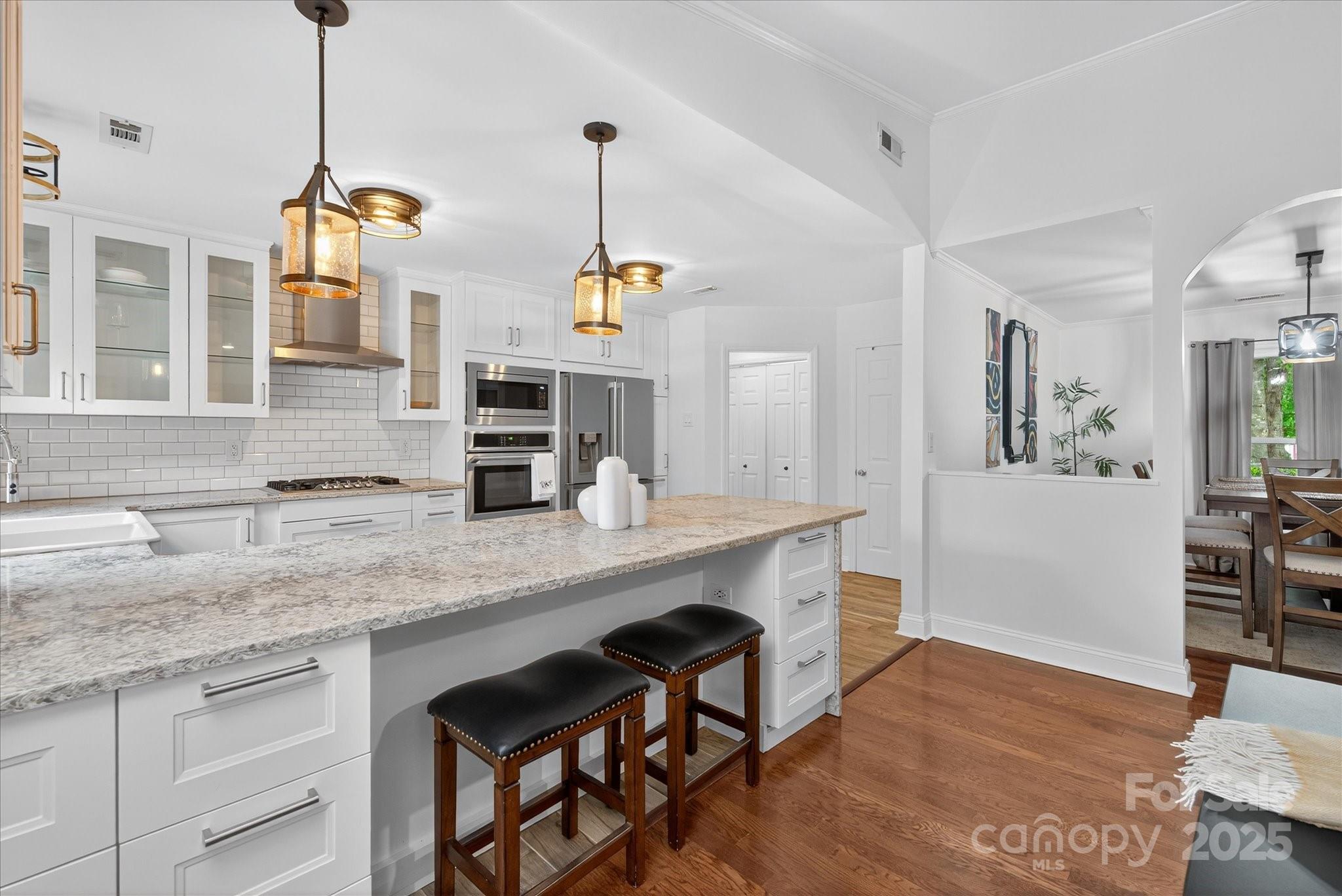 11710 Buckstone Lane Charlotte, NC 28277 - Photo 11 of 42 a kitchen with stainless steel appliances granite countertop a sink a window and chairs