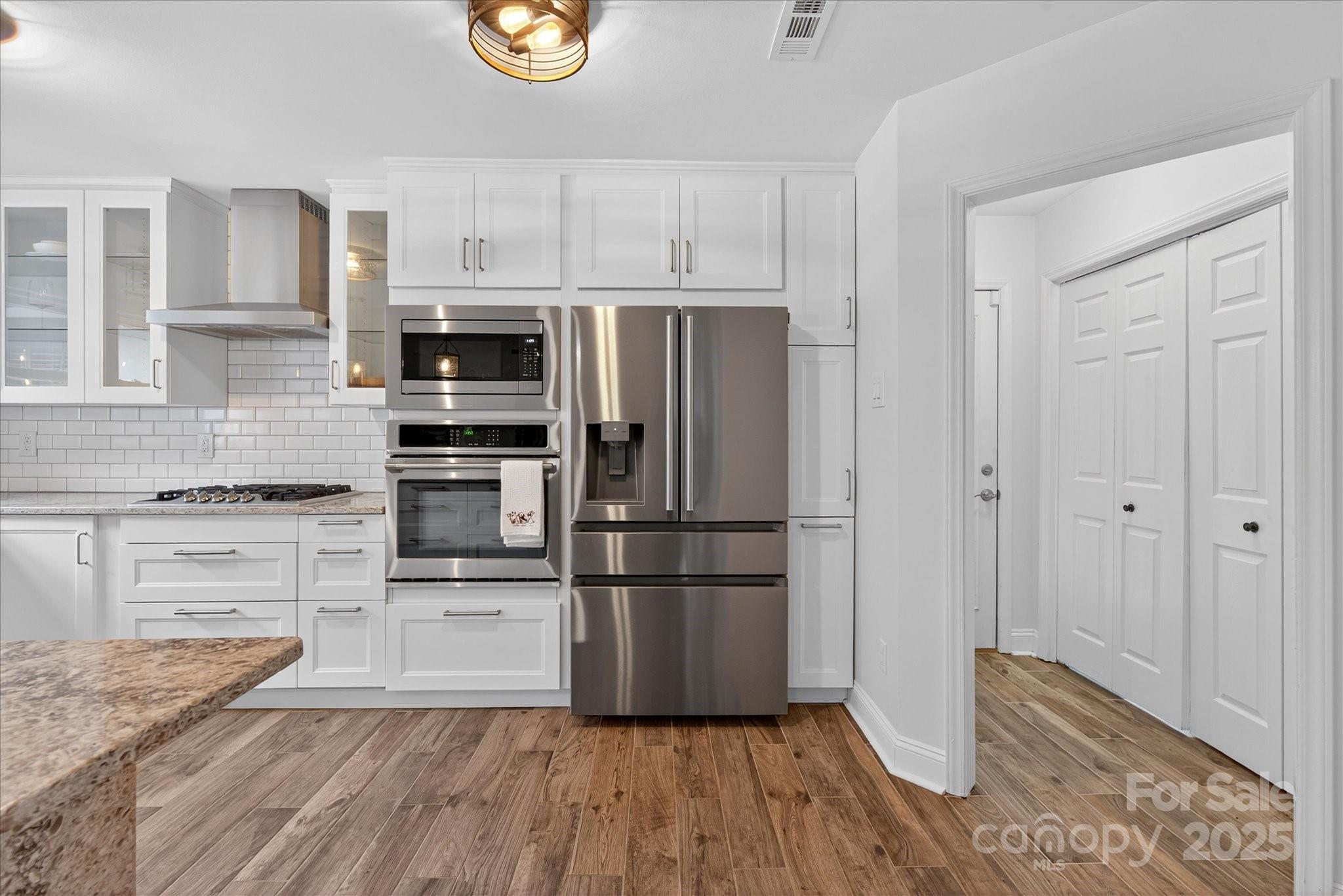 11710 Buckstone Lane Charlotte, NC 28277 - Photo 12 of 42 a kitchen with granite countertop a refrigerator and a stove top oven