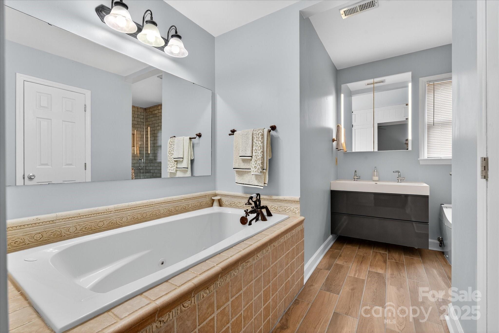 11710 Buckstone Lane Charlotte, NC 28277 - Photo 21 of 42 a spacious bathroom with a tub double sink and mirror