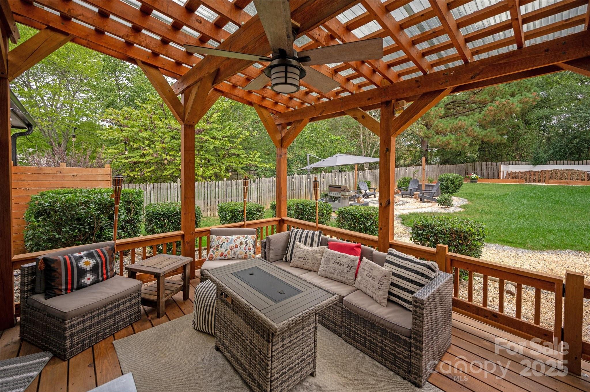 11710 Buckstone Lane Charlotte, NC 28277 - Photo 28 of 42 a view of a patio with a table chairs and a backyard