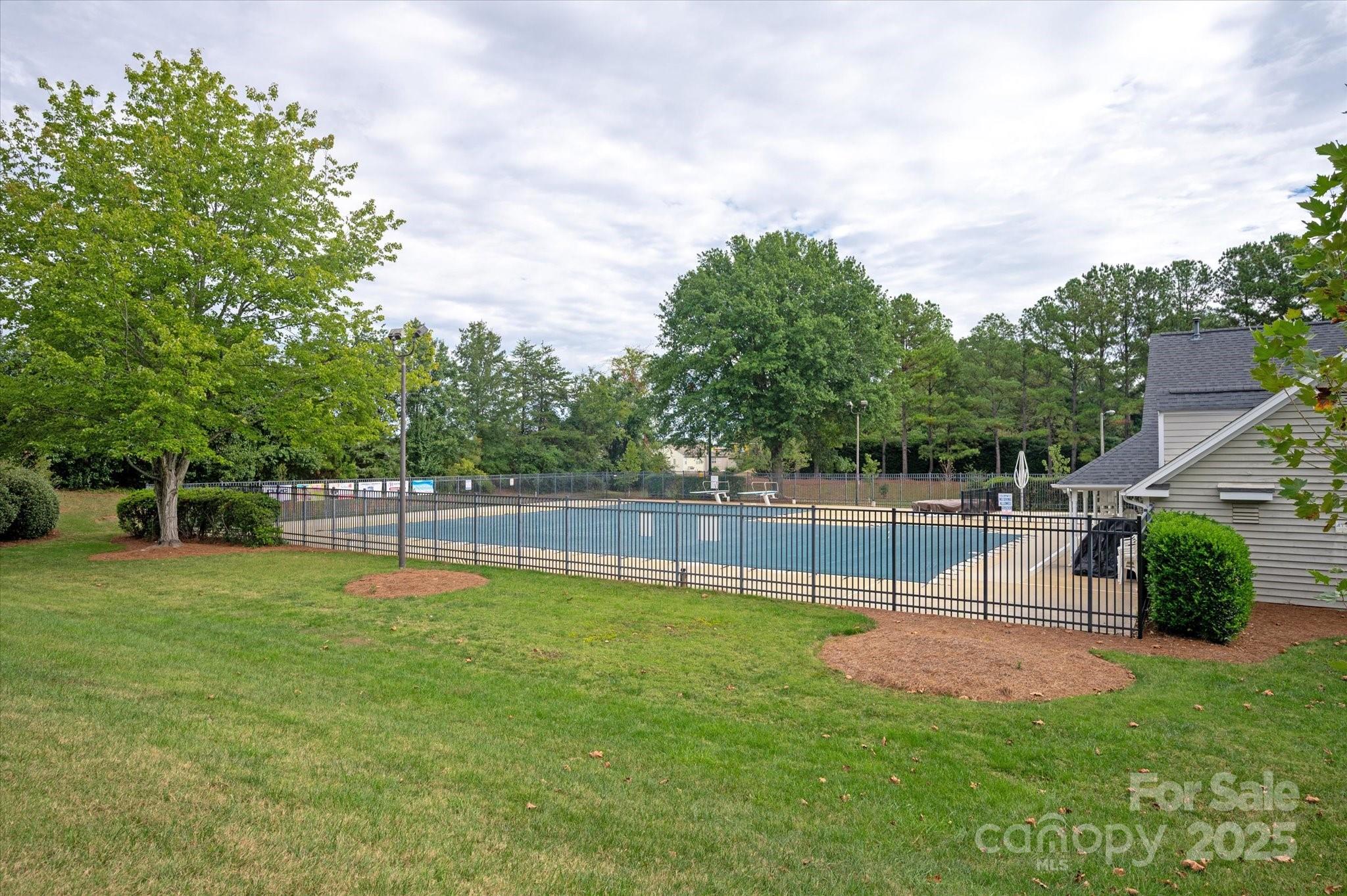 11710 Buckstone Lane Charlotte, NC 28277 - Photo 40 of 42 a swimming pool with lots of tress in the background
