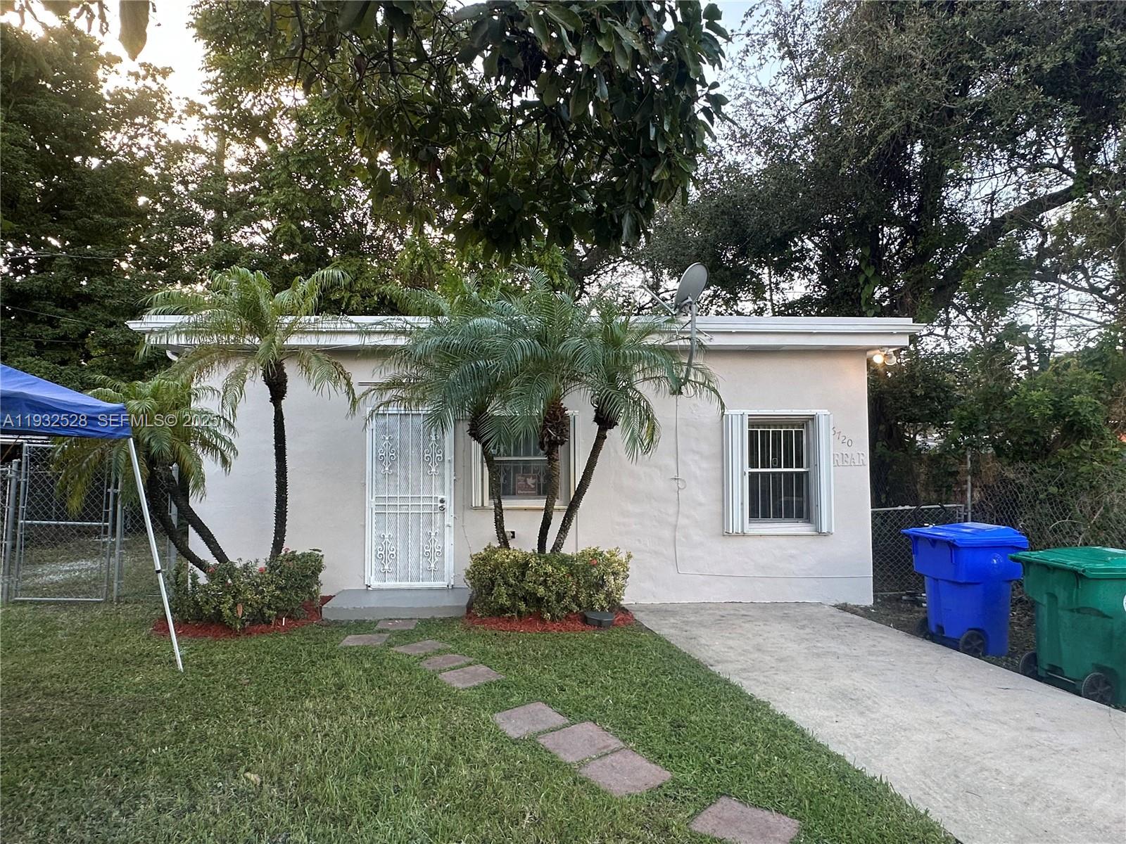 6720 Northwest 4th Avenue Miami, FL 33150 - Photo 4 of 5 a front view of a house with garden