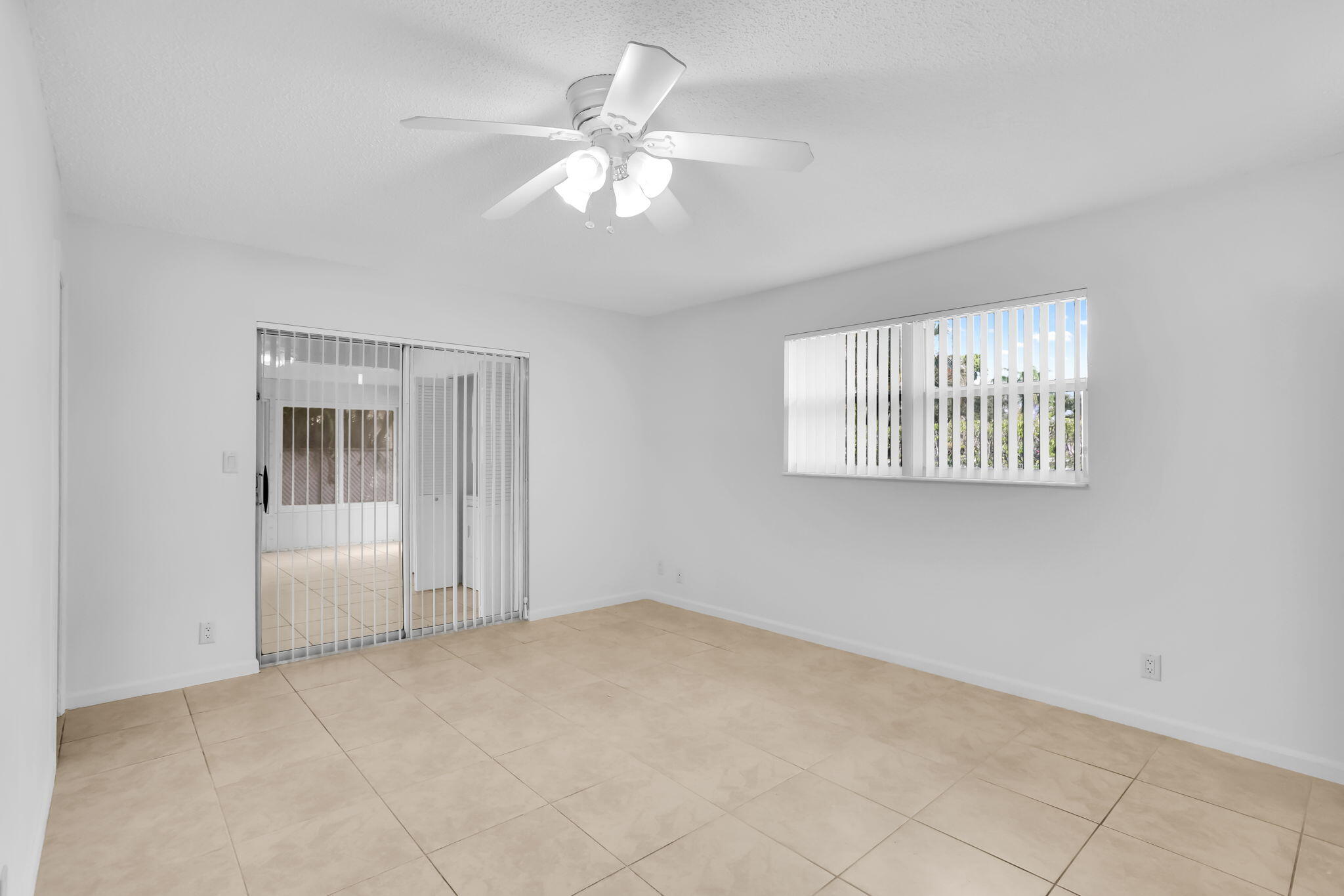 89 Lariat Circle Boca Raton, FL 33487 - Photo 19 of 31 an empty room with windows and fan
