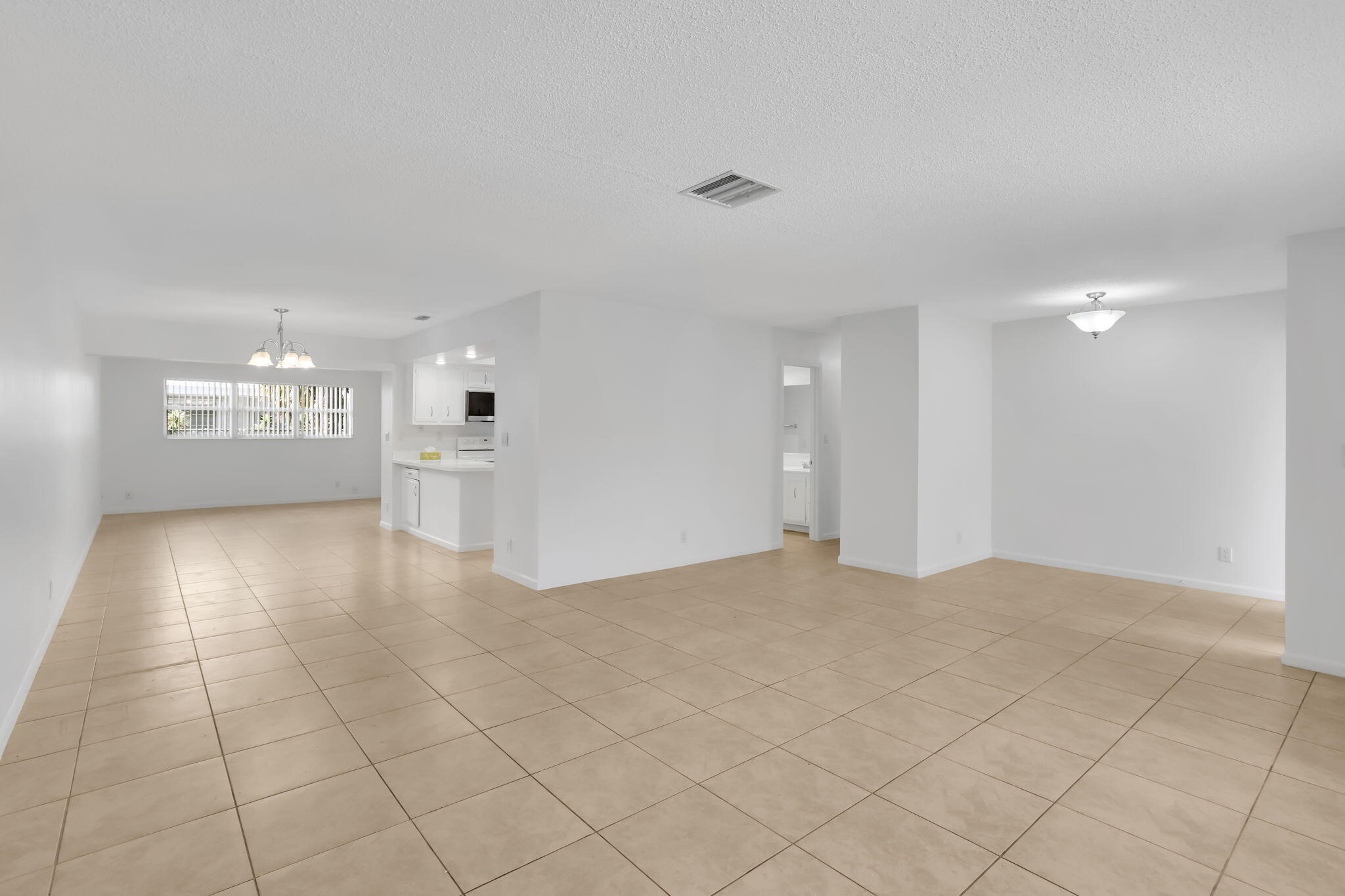 89 Lariat Circle Boca Raton, FL 33487 - Photo 6 of 31 a view of an empty room and a kitchen