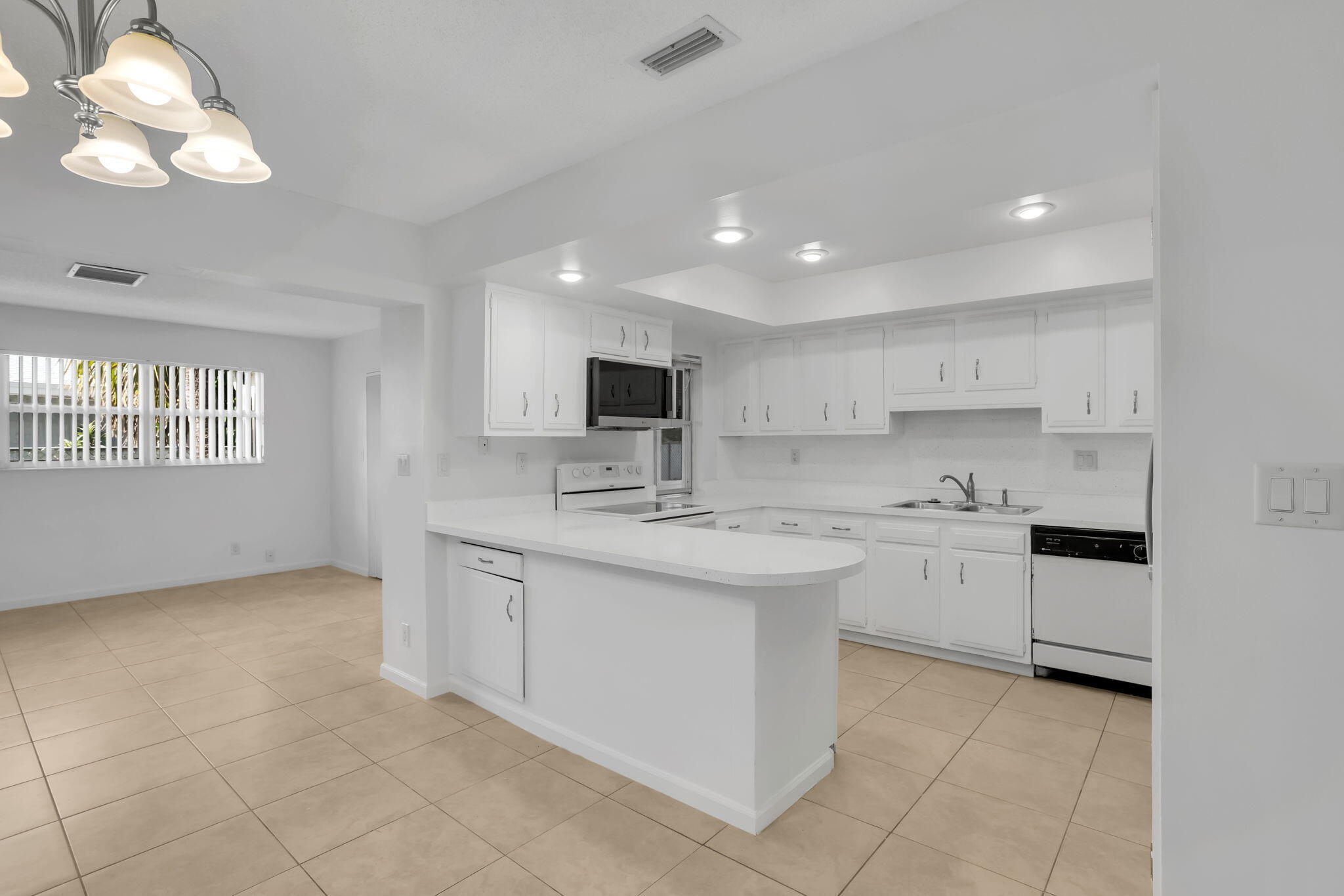 89 Lariat Circle Boca Raton, FL 33487 - Photo 8 of 31 a kitchen with a sink stove and cabinets