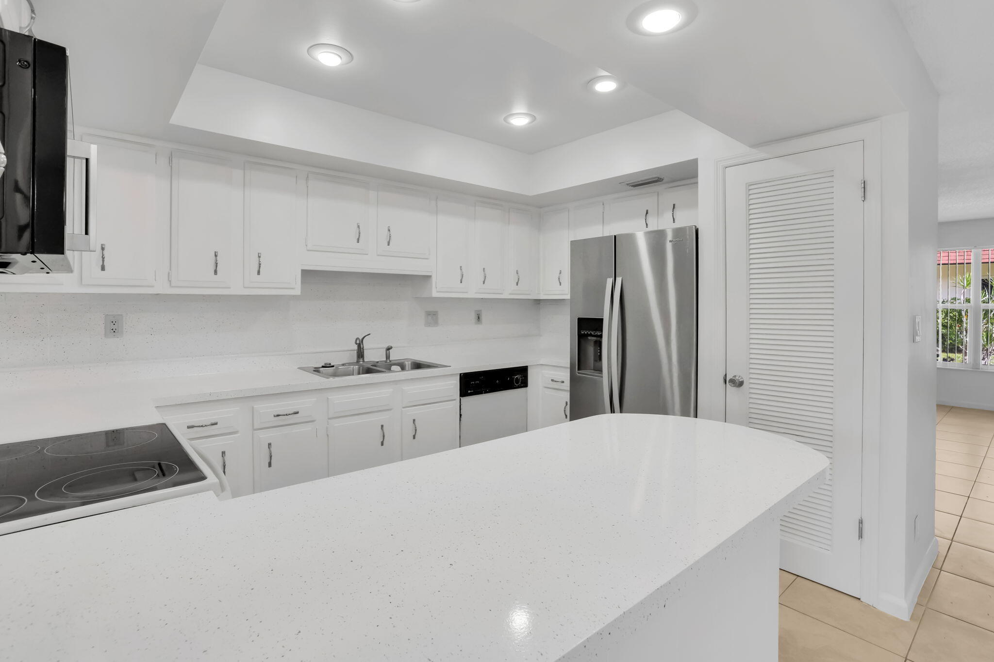 89 Lariat Circle Boca Raton, FL 33487 - Photo 9 of 31 a kitchen with stainless steel appliances a refrigerator sink and cabinets