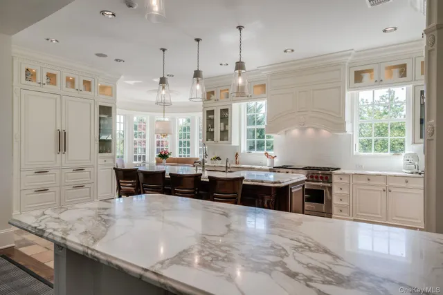 a large kitchen with stainless steel appliances granite countertop a lot of counter space and a sink