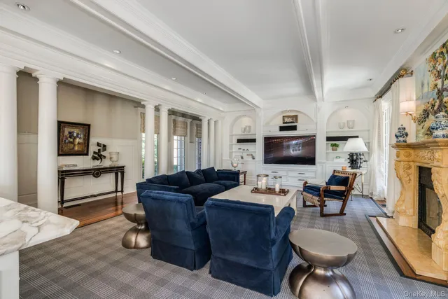 a living room with furniture and a chandelier