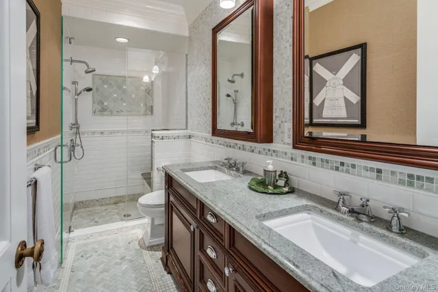 a living room with furniture chandelier and wooden floor