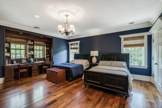 a bathroom with a granite countertop double vanity sink a mirror and a shower