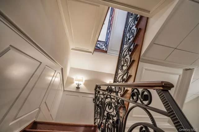a view of a hallway with wooden floor and windows