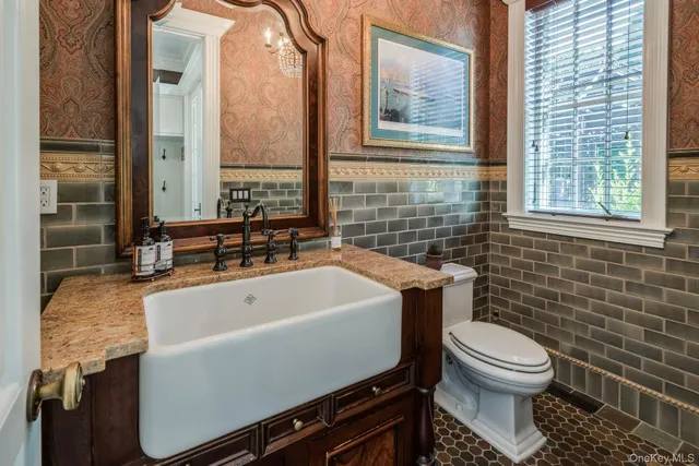 a bathroom with a toilet and a mirror