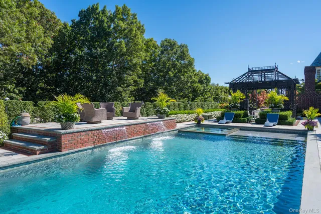 a view of a house with swimming pool and sitting area