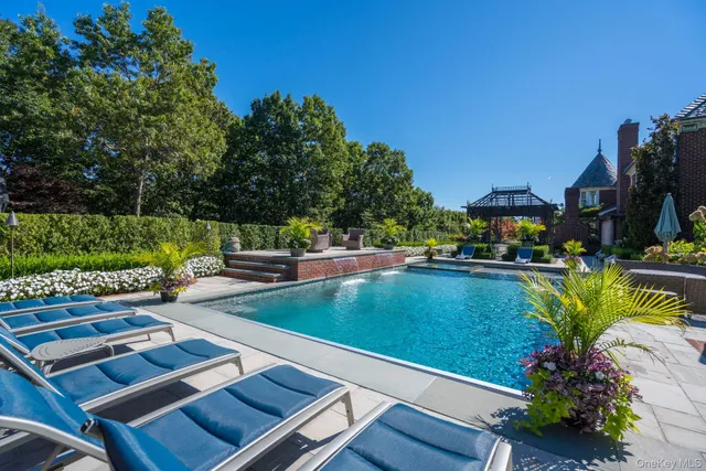 a view of a swimming pool with a table and a chairs